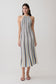 Woman wearing a striped blue and brown halter neck knit midi dress.