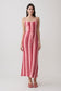 Woman wearing a pink and red striped crochet halter maxi dress.