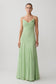 Woman wearing a light green chiffon maxi dress.