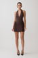 Woman wearing a brown halter neck mini dress.