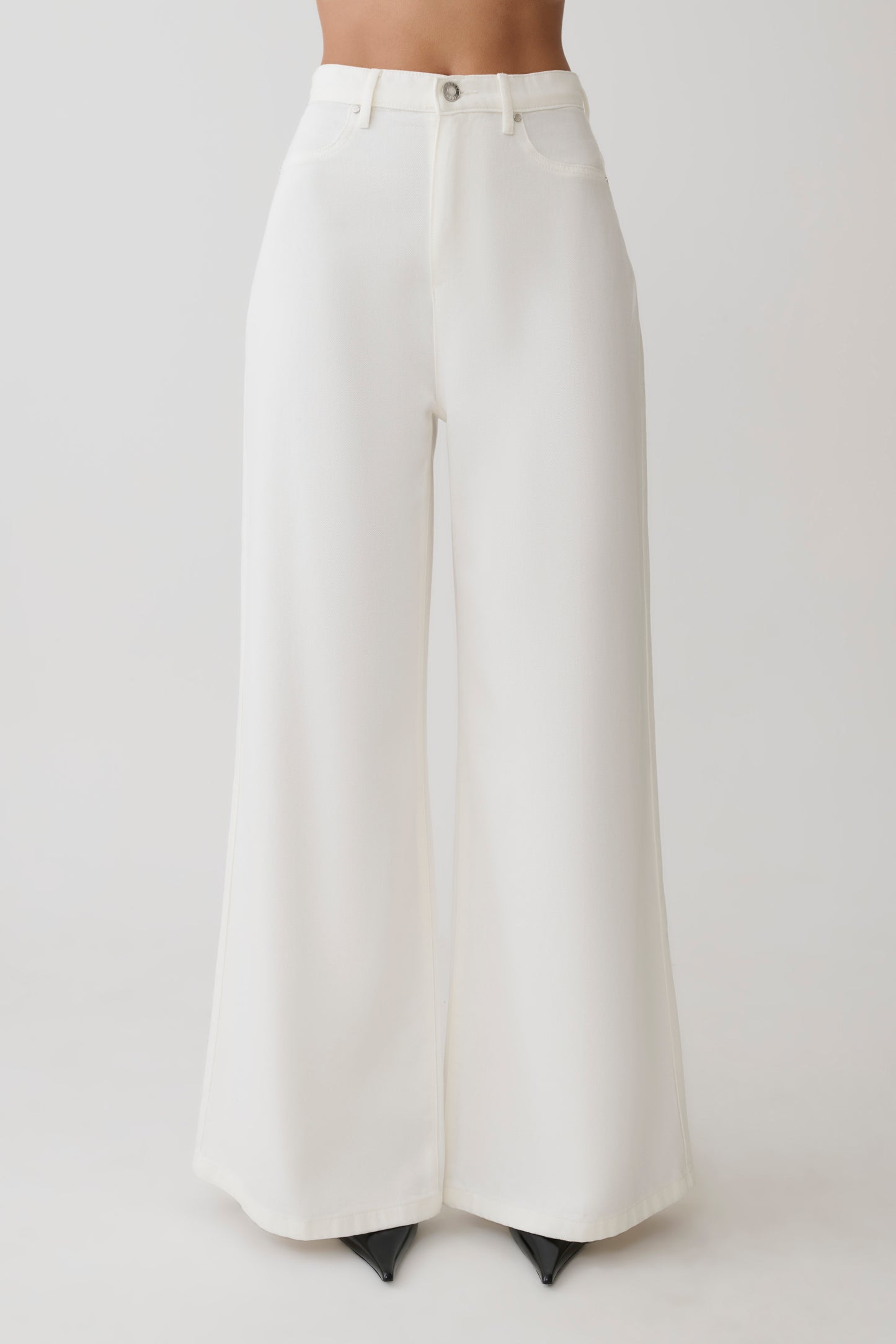 Woman wearing white wide-leg pants.