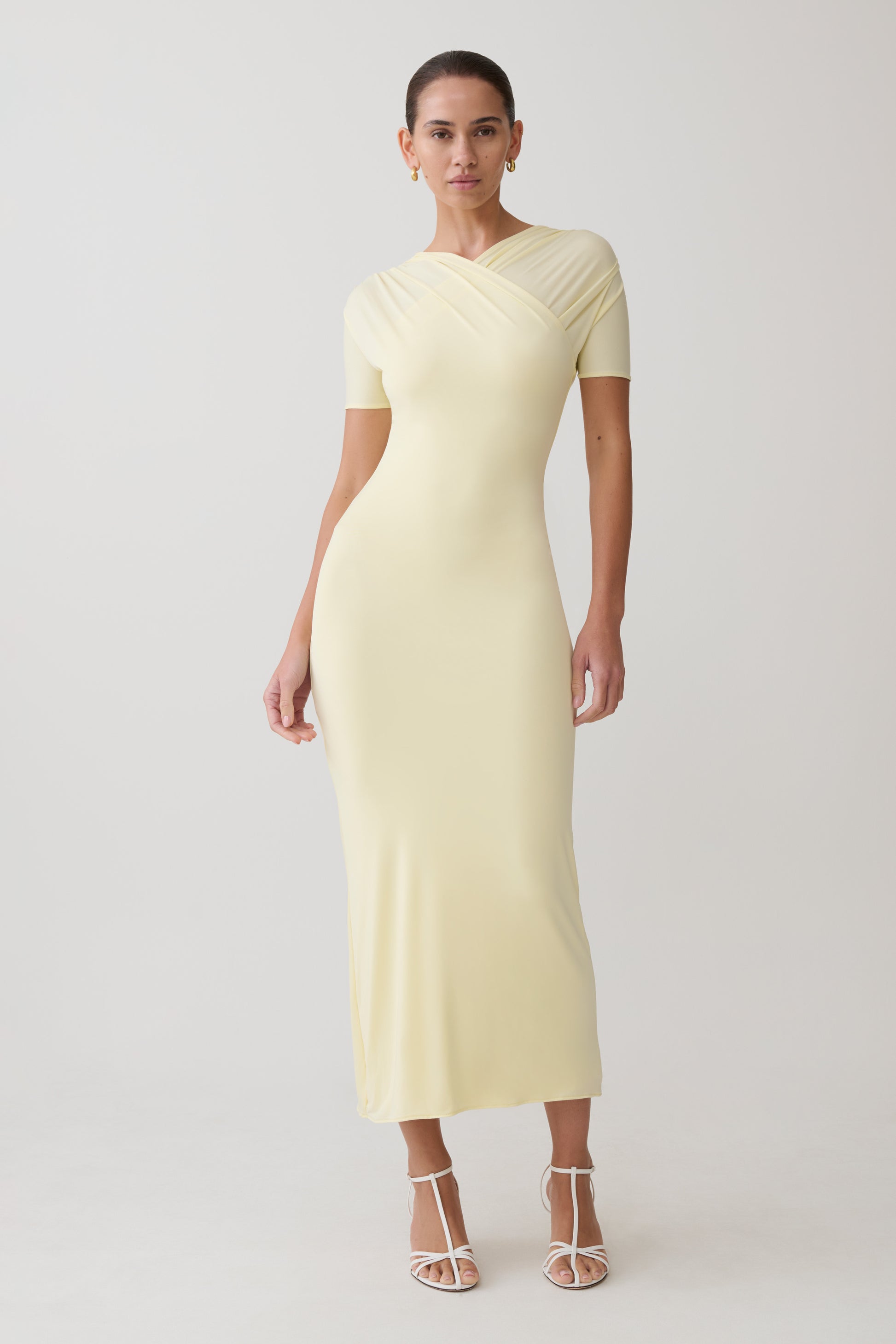 Woman wearing a light yellow maxi dress.