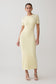 Woman wearing a light yellow maxi dress.