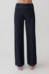 Woman wearing striped dark blue flared pants.