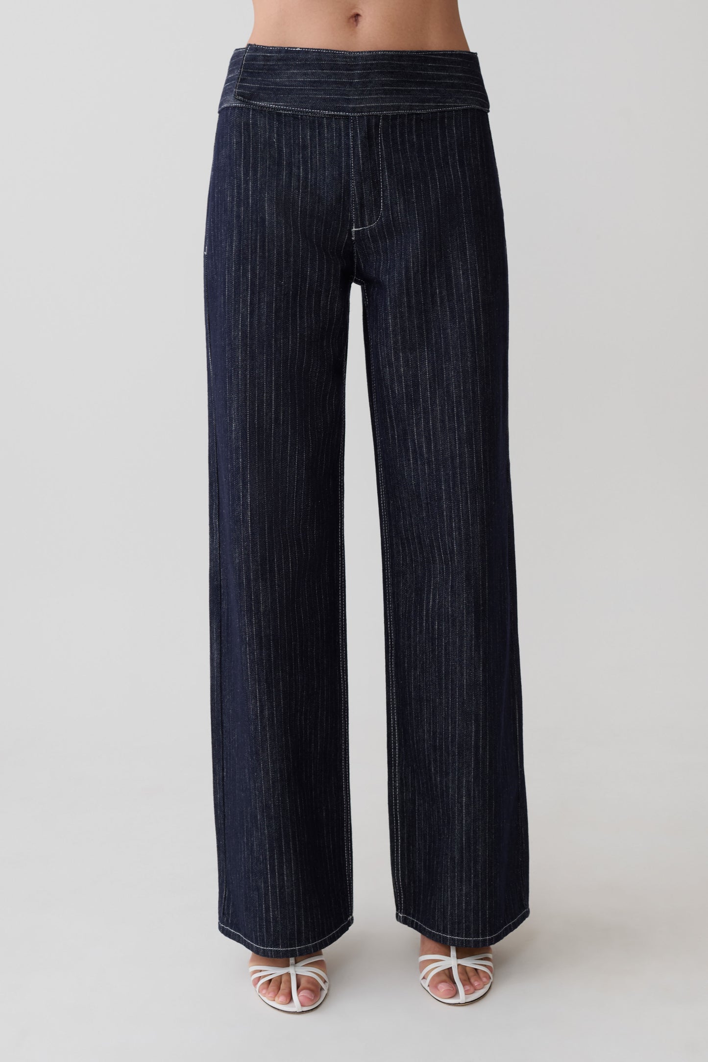 Woman wearing striped dark blue flared pants.