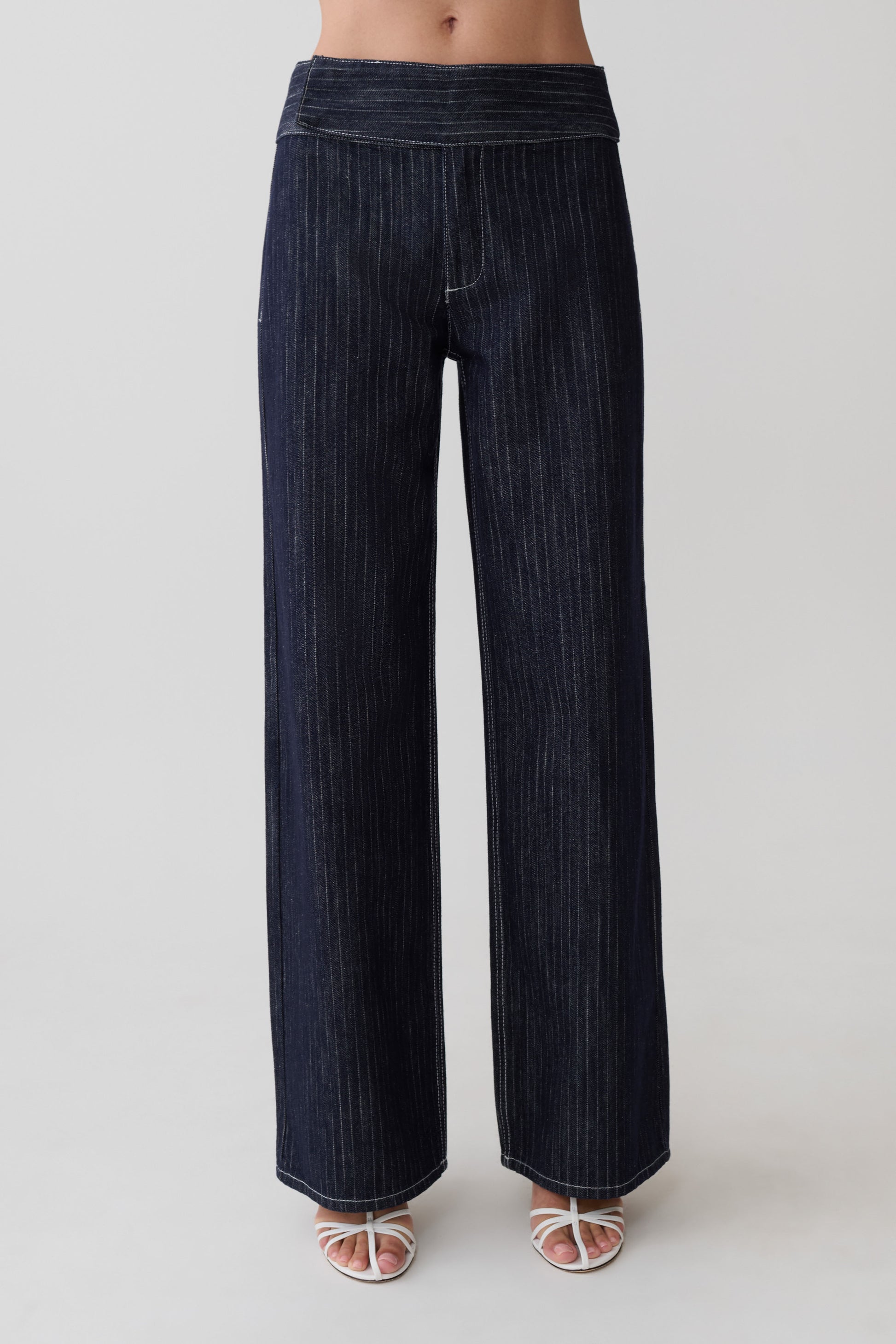 Woman wearing striped dark blue flared pants.