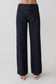 Woman wearing striped dark blue flared pants.