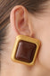 Gold square earring with brown centre.