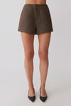 Woman wearing brown shorts.