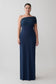 Woman wearing a navy one-shoulder gown.