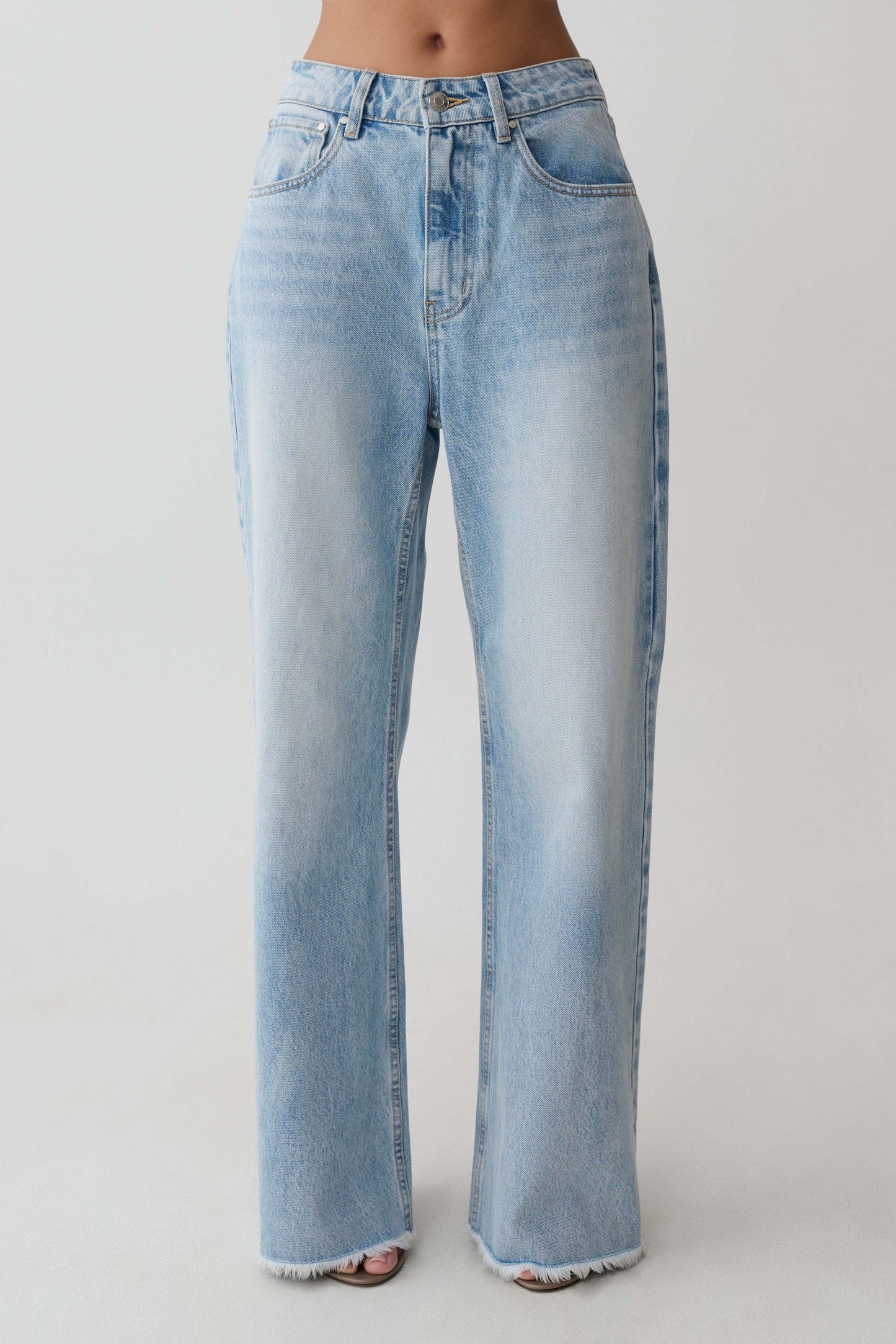 Light blue straight leg jeans with frayed hem.