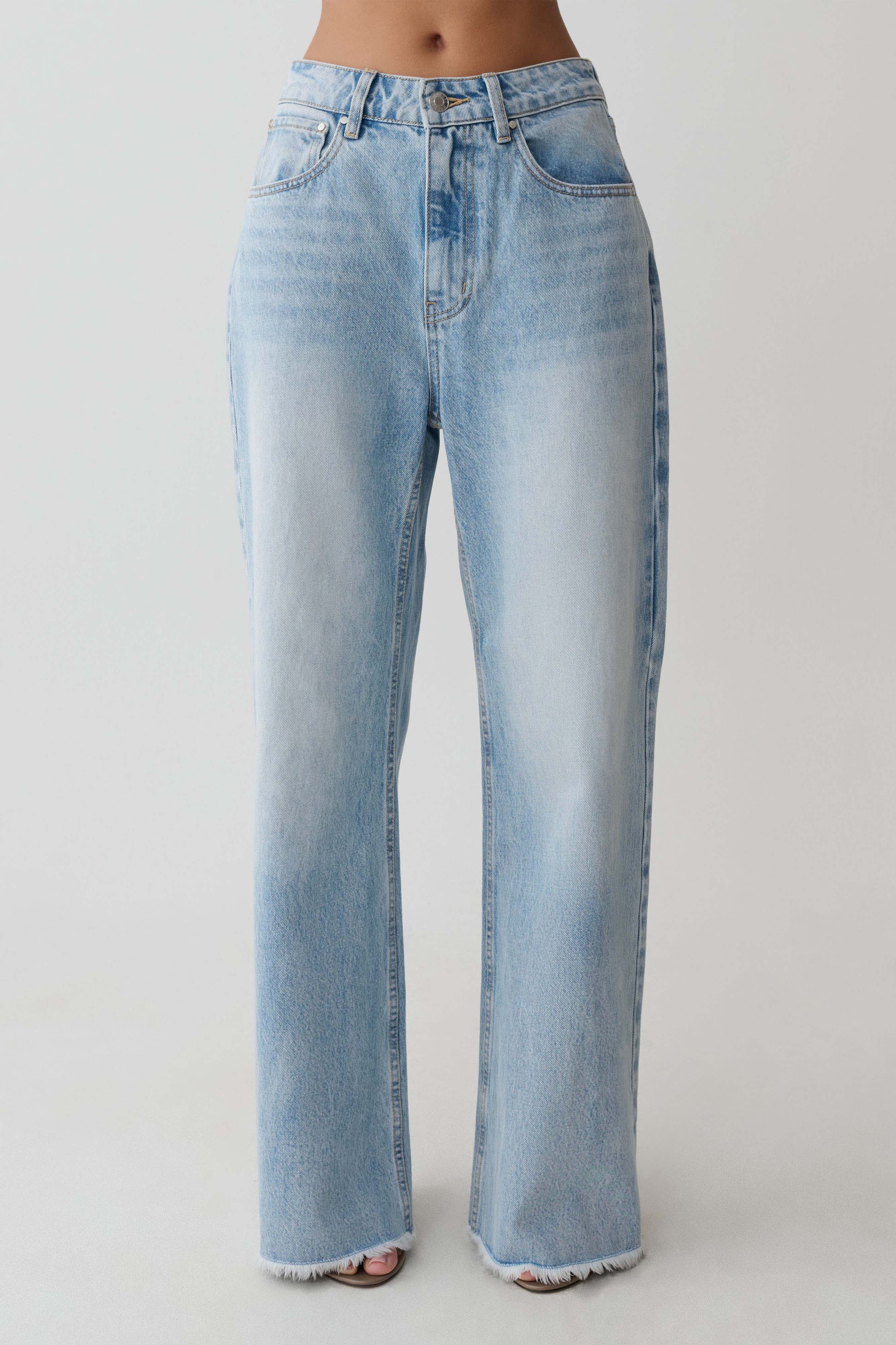 Light blue straight leg jeans with frayed hem.