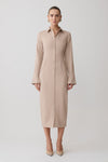 Woman wearing a beige long shirt dress on a white background