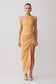 Woman wearing a yellow one-shoulder dress on a white background