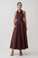 Woman wearing a brown sleeveless dress on a white background