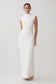 Woman wearing a white dress against a plain background