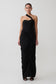 Woman wearing a black one-shoulder dress on a white background