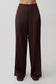 Woman wearing brown silk pants.