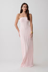 Woman wearing a strapless pink ribbed maxi dress.