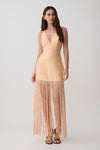 Woman wearing a v neck orange fringe maxi dress.