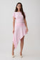 Woman wearing a pink modal hankie set with an asymmetrical midi skirt.