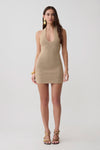 Woman wearing a lurex halter mini dress.