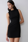 Woman wearing a black stretch crepe mini dress.
