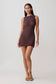 Woman wearing a brown crochet mini dress.