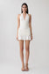 Woman wearing a white halter mini dress.