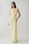 Woman wearing a light yellow chiffon maxi dress.