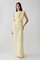 Woman wearing a light yellow chiffon maxi dress.