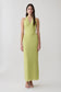 Woman wearing a light green halter maxi dress.