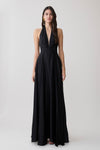 Woman wearing a black halter buttoned maxi dress.