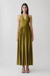 Woman wearing a green halter maxi dress.