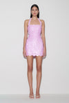 Woman wearing pink sequin halter mini dress.