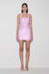 Woman wearing pink sequin halter mini dress.