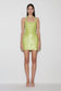 Woman wearing a green sequin halter mini dress.