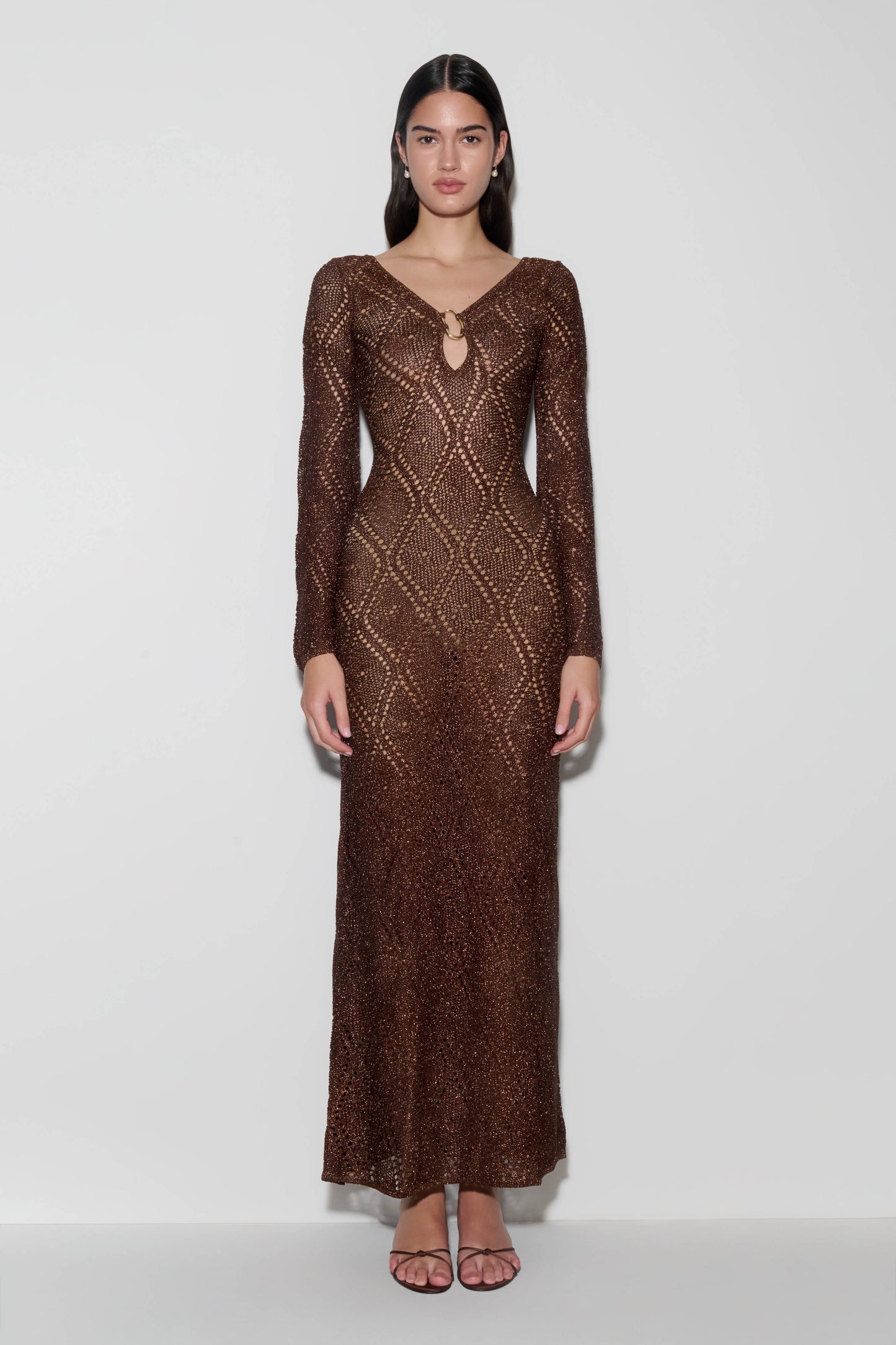 Woman wearing a brown lurex crochet maxi dress.
