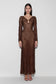 Woman wearing a brown lurex crochet maxi dress.