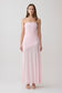 Woman wearing a pink strapless ruched mesh maxi dress.