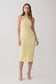 Woman wearing a yellow pointelle midi dress.