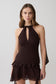 Woman wearing a brown chiffon halter sleeveless top with matching mini skirt.