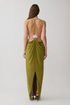 Woman wearing a green low back halter maxi dress. 
