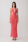 Woman wearing a coral halter knit maxi dress.