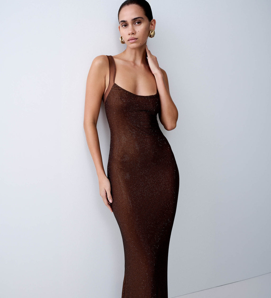 Woman wearing a brown diamante maxi dress.