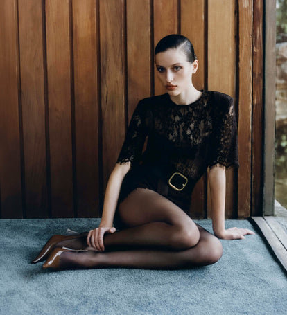 Image of woman in brown knit top.
