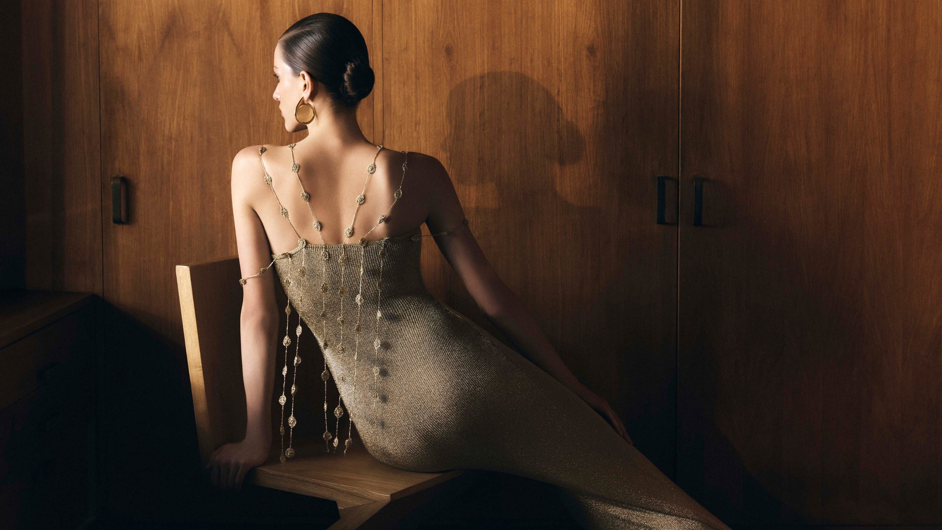 Image of woman in gold knit dress.