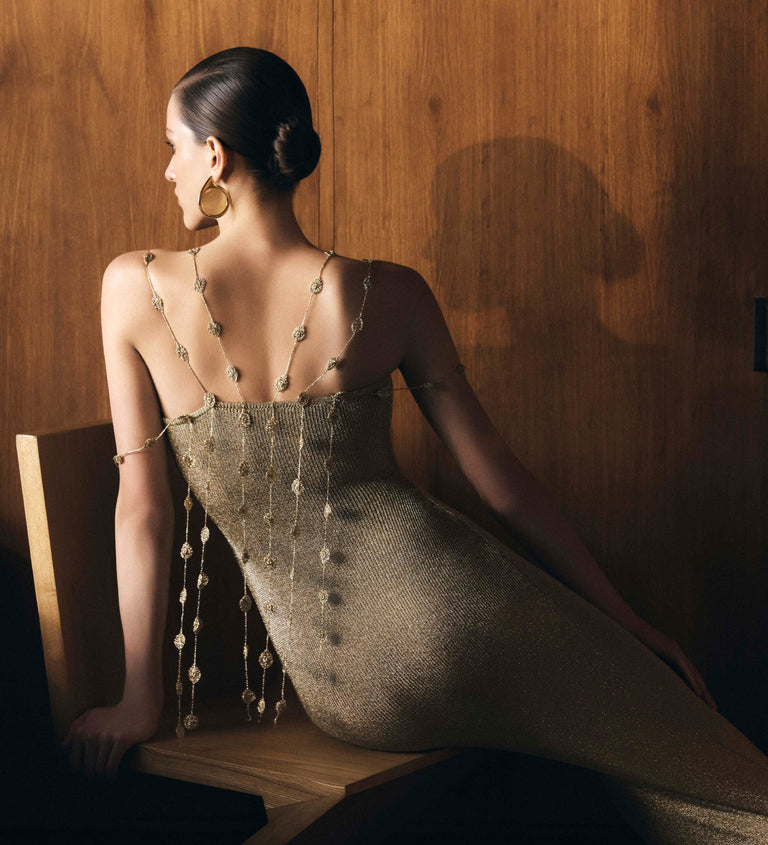 Image of woman in gold knit dress.