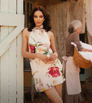 Image of woman in floral mini dress.