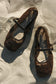 Brown lace applique flats.